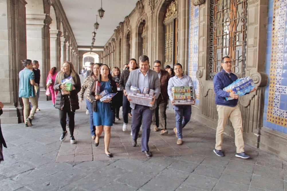 El jefe de Gobierno de la Ciudad de México, José Ramón Amieva (centro), lleva víveres al centro de acopio ubicado en Plaza de la Constitución s/n, entre la calle 20 de noviembre y 5 de febrero. (CORTESÍA)