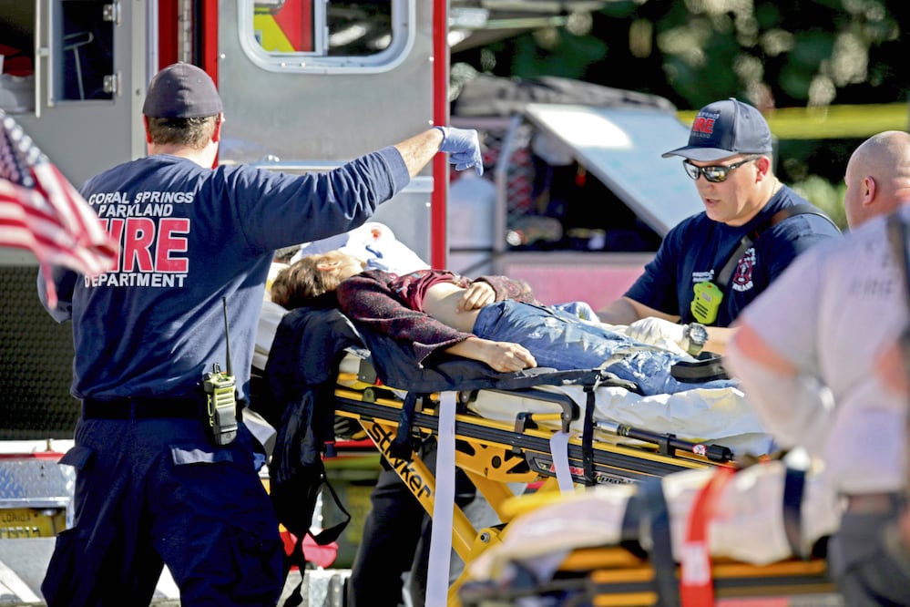 Paramédicos atienden a una de las víctimas del tiroteo en la escuela Stoneman Douglas, ubicada en Parkland, en el sur de Florida. De acuerdo con las autoridades, al menos 17 personas murieron y 15 resultaron heridas (JOHN MCCALL. AP)