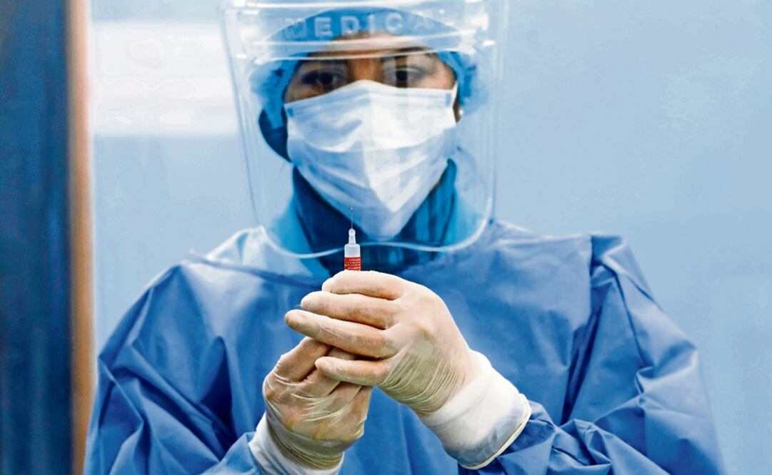 A healthcare worker wears protective gear – Mariana Bazo/Xinhua