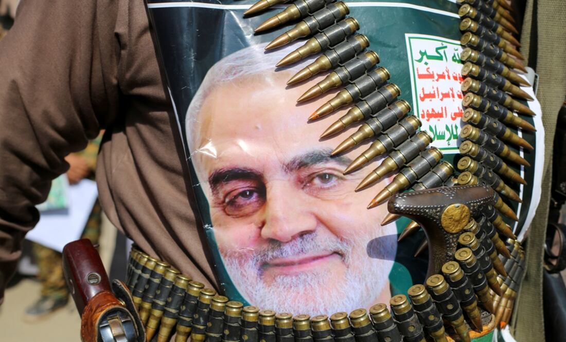 A supporter of the Houthis has a poster attached to his waist of Iranian Major-General Qassem Soleimani. The poster reads: "God is the Greatest, Death to America, Death to Israel, Curse on the Jews, Victory to Islam" - Photo: Naif Rahma/REUTERS