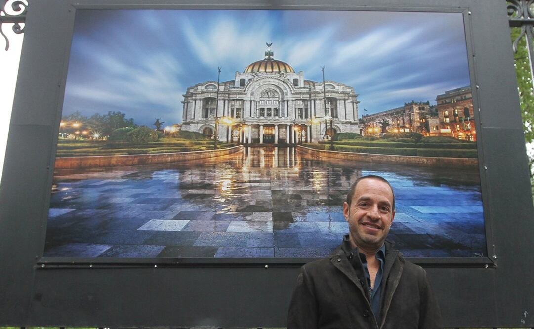 El fotógrafo Pepe Soho posa en frente de una imagen del Palacio de Bellas Artes. Foto: Notimex
