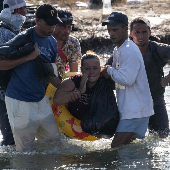 María Argentina, hondureña de 32 años y quien no tiene piernas, es ayudada por otros migrantes para cruzar el Río Grande (Bravo), hacia Eagle Pass, Texas. FOTO: ANDREW CABALLERO-REYNOLDS. AFP