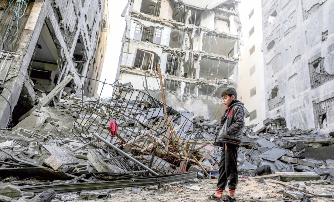 Un niño palestino observa las ruinas de un edificio de departamentos que fue destruido tras un ataque aéreo israelí en la ciudad de Gaza. (MOHAMMED SABER. EFE)