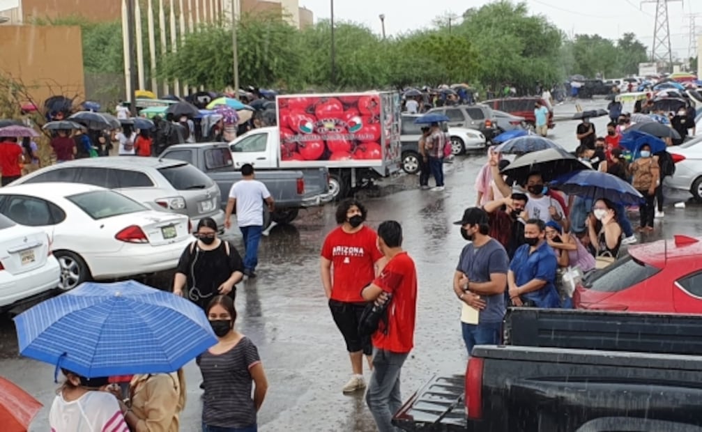 Bajo la lluvia, miles de jóvenes esperan ser vacunados contra Covid-19 en Hermosillo