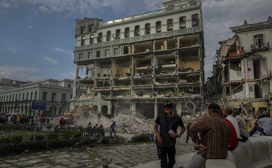 La gente observa los esfuerzos de rescate en el lugar de una explosión mortal que destruyó el Hotel Saratoga de cinco estrellas, en La Habana. Foto: AP