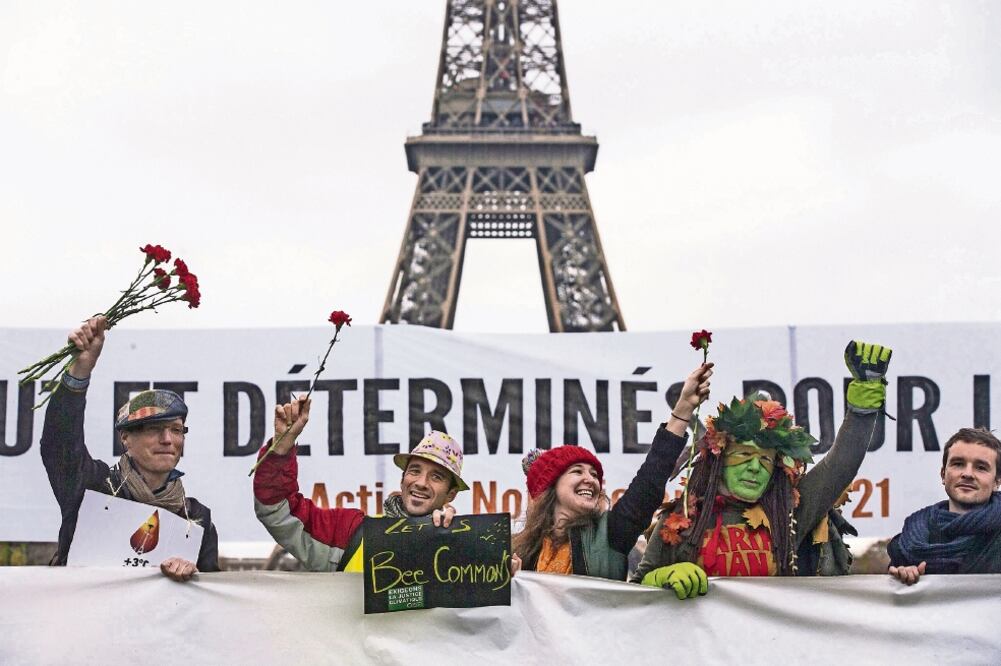 Miles de personas se reunieron ayer en los alrededores de la Torre Eiffel, en París, para festejar el pacto a favor del planeta (ETIENNE LAURENT. EFE)