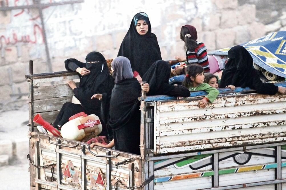 Sirias que huyeron de los grupos yihadistas viajan sobre un vehículo, en Aleppo (KHALIL ASHAWI. REUTERS)