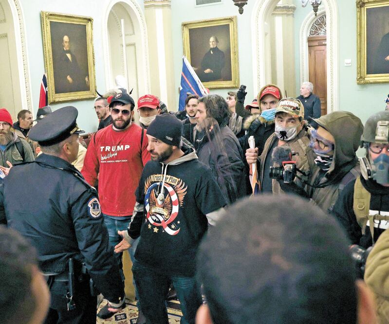 Manifestante s pro Trump, el miércoles pasado, al encararse con policías tras irrumpir en el Capitolio, en Washington. Foto: AFP