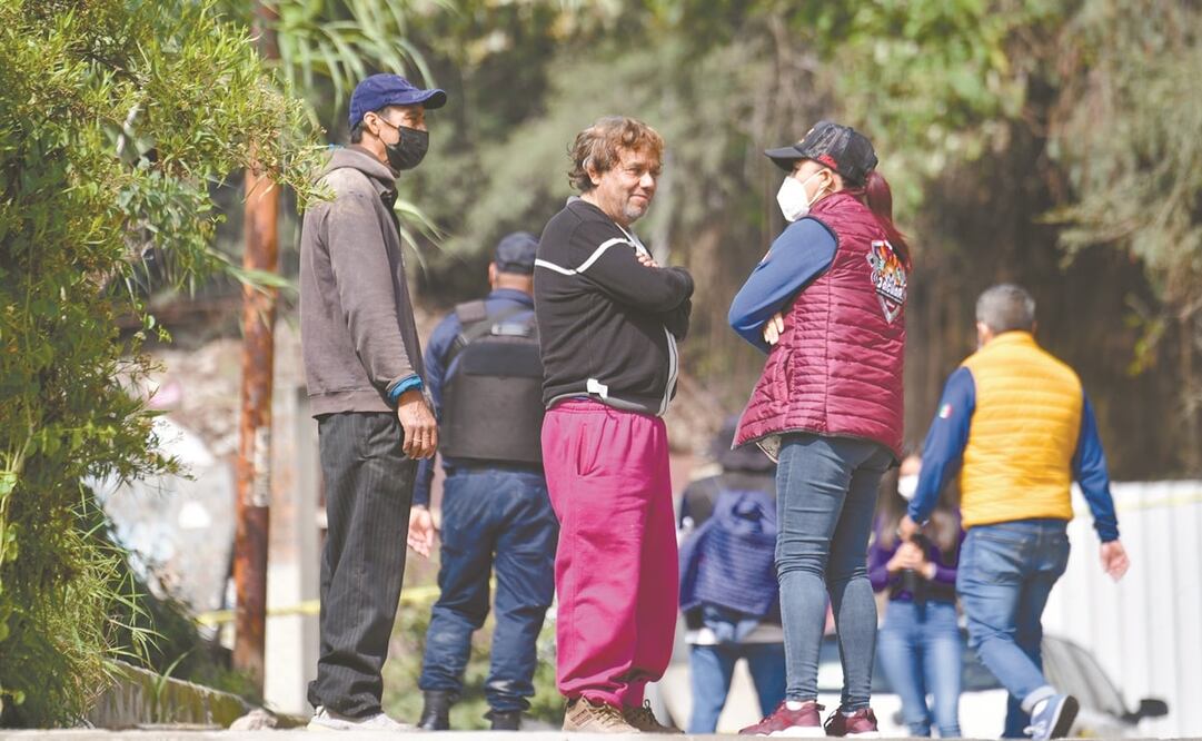 Luego de salir del hospital, Arturo (centro) llegó por su propio pie a la colonia La Palma para constatar cómo había quedado su vivienda. Pide que le dejen sacar su taxi. Foto: Hugo García. El Universal