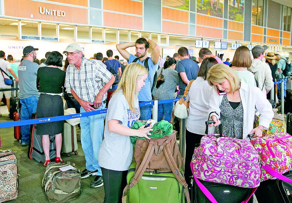 Pasajeros hacían largas filas en el aeropuerto de Austin, Texas, a la espera de que United Airlines anunciara la reanudación de vuelos, tras un fallo, ayer (JAY JANNER / AP)