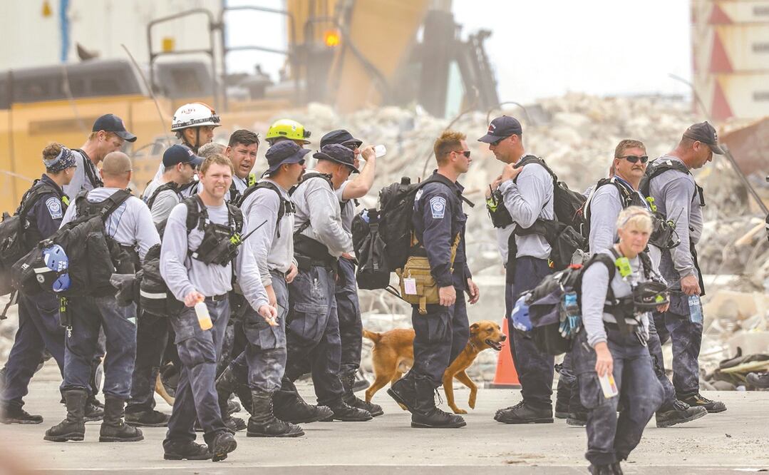 Integrantes del equipo de búsqueda y rescate, ayer luego de trabajar entre los escombros del edificio Champlain Towers, en Surfside. Foto: AL DIAZ. AP