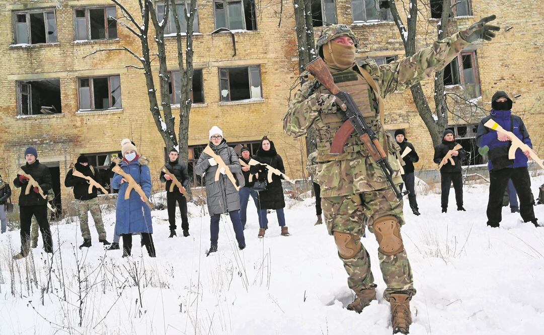 Un instructor militar entrena a civiles con réplicas de rifles rusos en una fábrica abandonada en Kiev. Los instructores enseñan a miembros del grupo conocido como Resistencia Total. Foto: Sergei Supinsky. AFP