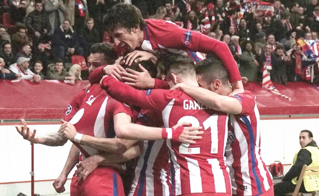 Saúl Ñíguez abrió el marcador para el Atleti; lo felicitaron sus compañeros. (PATRIK STOLLARZ. AFP)