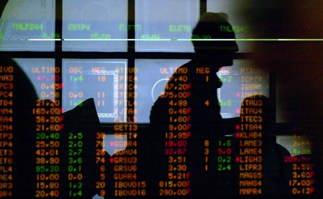 Investors reflected on a window in front of an electronic stock board. The integration of global markets is evident in the affects of events and trends around the world on local exchanges - Photo: AP