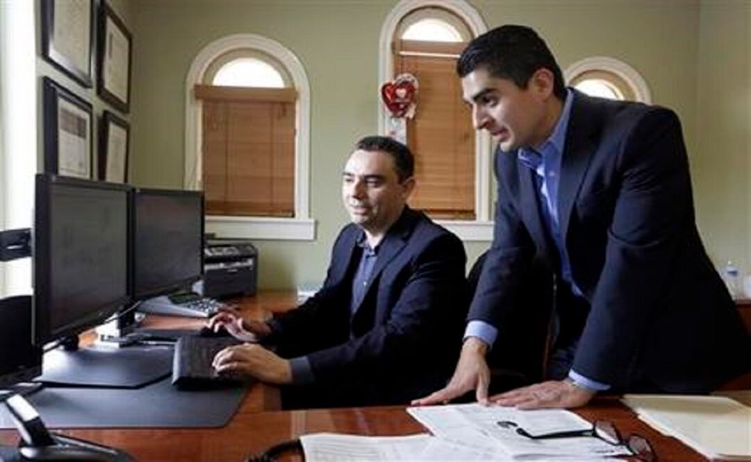 Certified financial planners Aarón Muñoz (left) and Gilbert Cerda at their offices in Downey, California. (Photo: AP) 