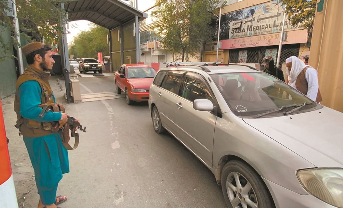 Talibanes revisan los vehículos a la entrada de la Zona Verde, donde se encuentran la mayoría de las embajadas en Kabul. Foto: EFE