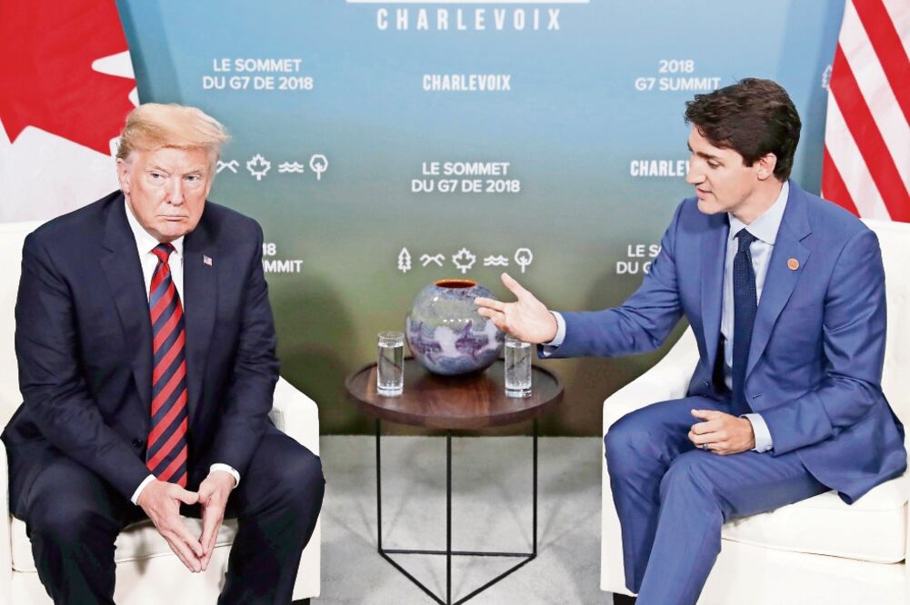 Donald Trump, presidente de EU, y Justin Trudeau, primer ministro canadiense durante una reunión que sostuvieron el pasado 8 de junio con motivo del encuentro del G7 en Quebec, Canadá. Foto: SAUL LOEB. AFP