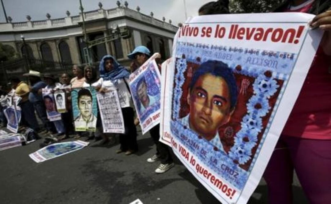 Relatives hold pictures of some of the 43 missing students of Ayotzinapa College, as they take part in a protest to demand justice for the missing students, near the Interior Ministry in Mexico City. REUTERS/Henry Romero
