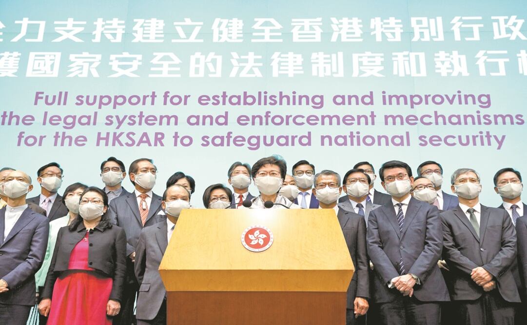 Hong Kong Chief Executive Carrie Lam, center, and other officials attend a press conference in Hong Kong after returning from China's National People's Congress (NPC) - Photo: Kin Cheung/AP