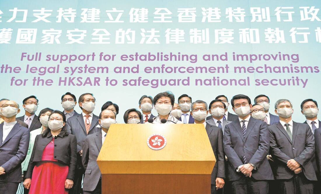 Hong Kong Chief Executive Carrie Lam, center, and other officials attend a press conference in Hong Kong after returning from China's National People's Congress (NPC) - Photo: Kin Cheung/AP