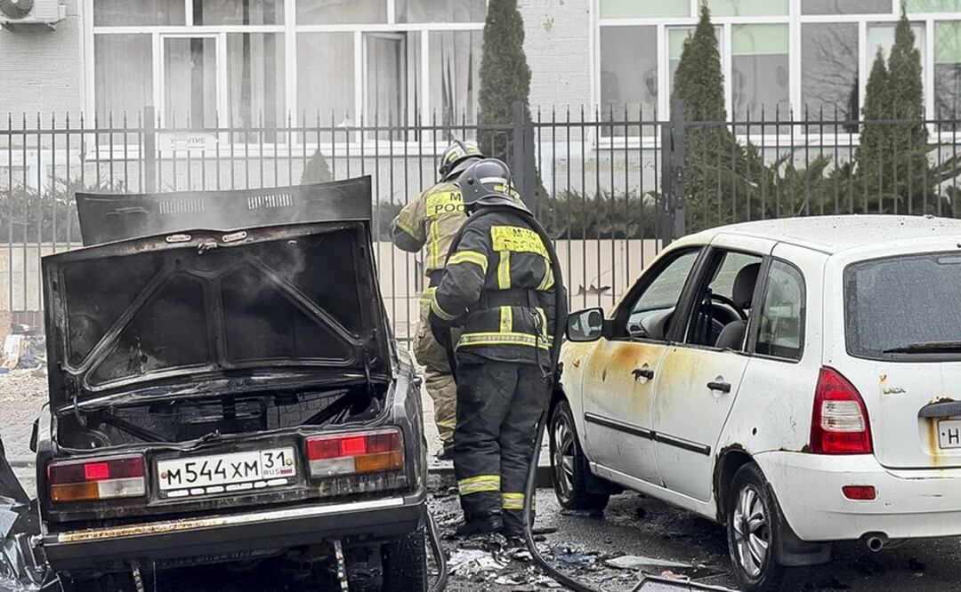 Trabajadores de emergencia trabajan en autos dañados y quemados tras la caída de proyectiles desde el lado Ucraniano, en Belgorod, Rusia. Foto: AP