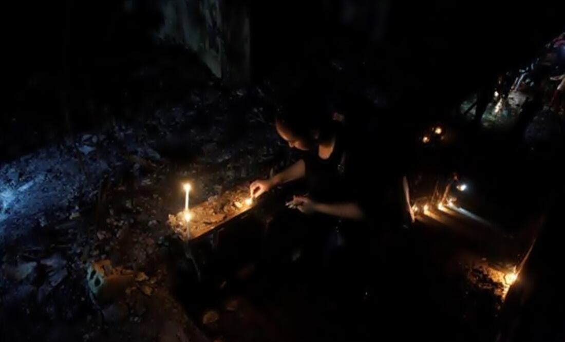 A woman lights a candle at the site after a suicide bombing in the Karrada shopping area. (Photo: Reuters)