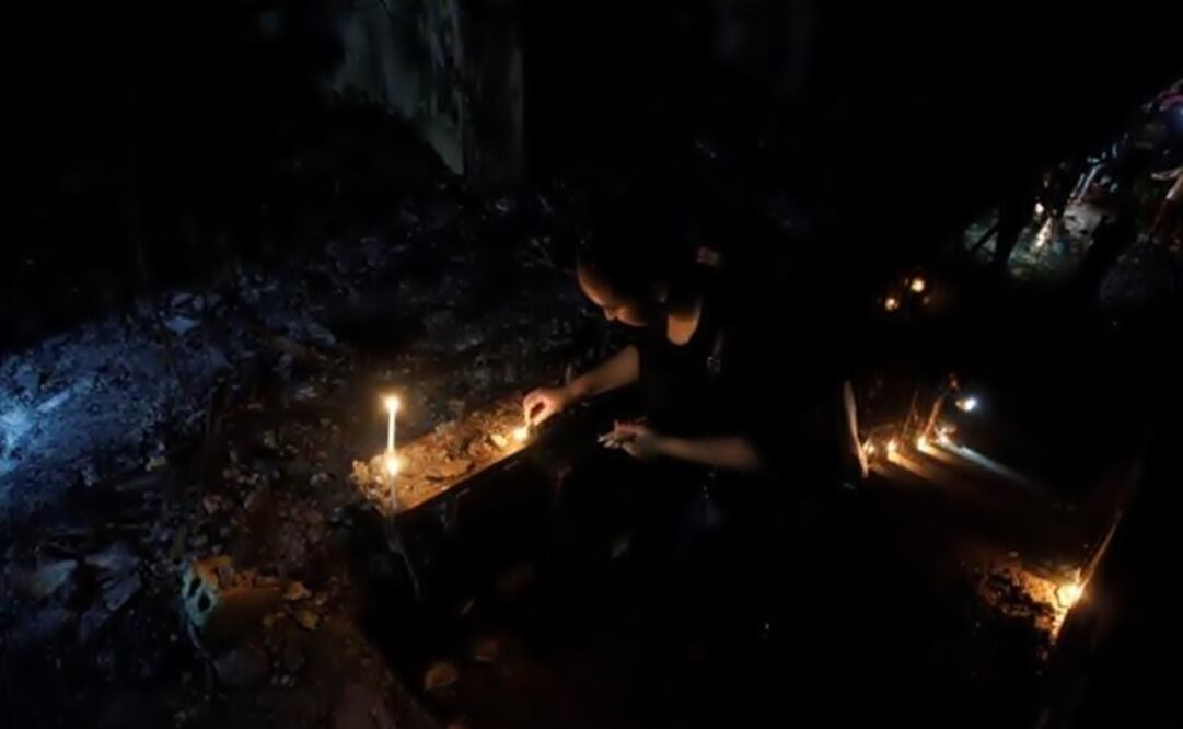 A woman lights a candle at the site after a suicide bombing in the Karrada shopping area. (Photo: Reuters)