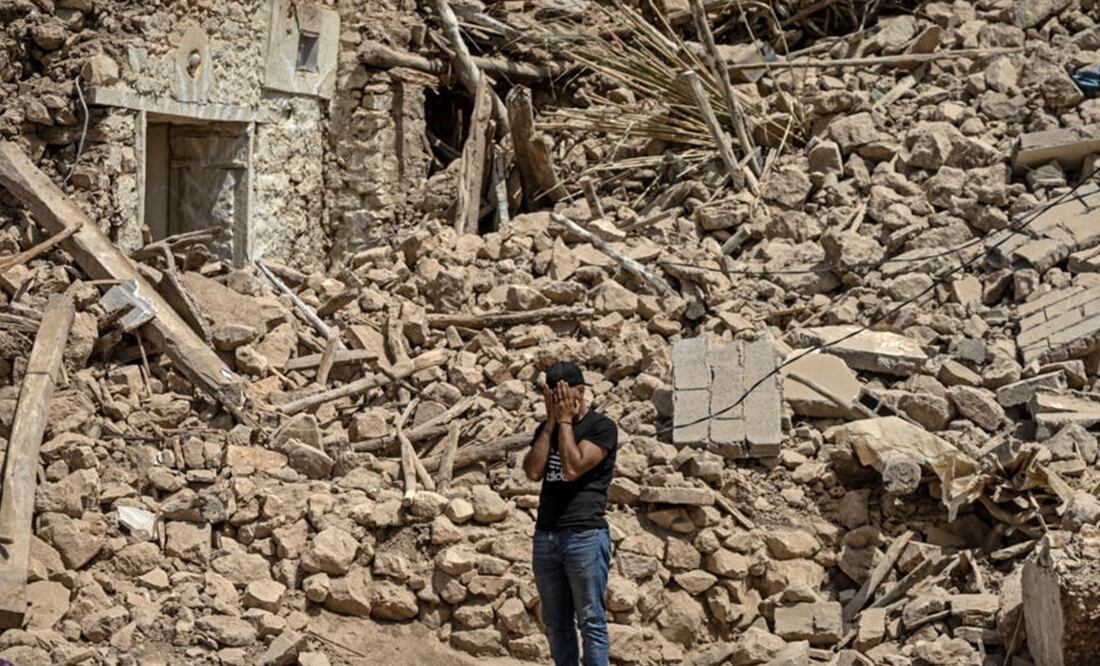 Un voluntario llora el 12 de septiembre de 2023 entre los escombros de Douzrou, una aldea que quedó destruida por el sismo que golpeó Marruecos. Foto: AFP