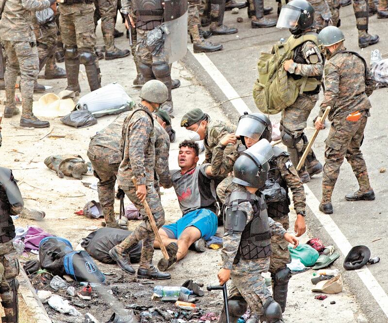 Soldados guatemaltecos atiendieron a un migrante hondureño tras los enfrentamientos registrados por la mañana en Vado Hondo, Guatemala. SANDRA SEBASTIAN. AP