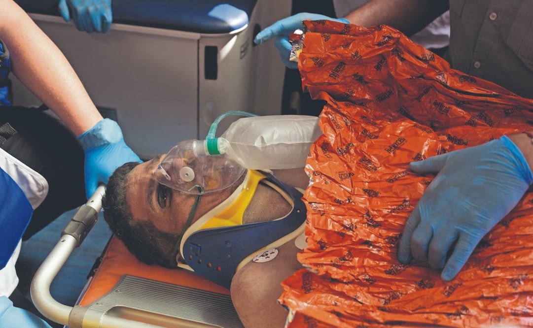 Rescatistas llevan a Hernán Gil a una ambulancia, tras sacarlo de entre escombros, en Catia La Mar. Foto: Fernando Vergara/ AP
