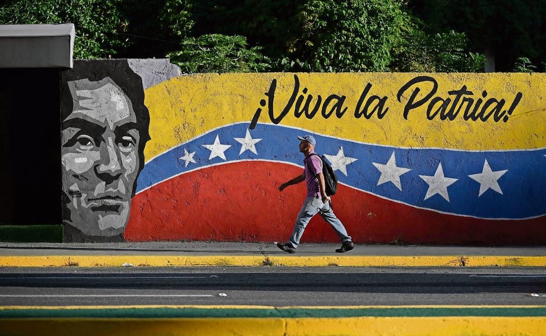 Un venezolano, junto a un mural que representa a Simón Bolívar, en Caracas. Foto: Federico Parra / AP