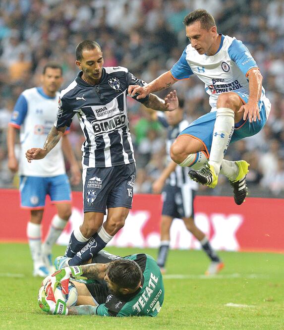 Édgar Castillo (izq.) estorbó a Christian Giménez (der.) para que el portero Jonathan Orozco controlara el balón (MIGUEL SIERRA. EFE)