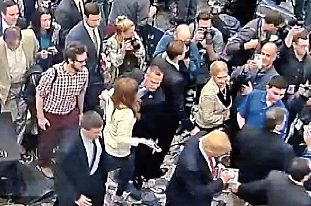 El jefe de campaña de Trump, Corey Lewandowski (centro) jalonea del brazo a la periodista Michelle Fields, en esta imagen tomada de un video grabado el 8 de marzo y difundido ayer por la policía de Florida (REUTERS)