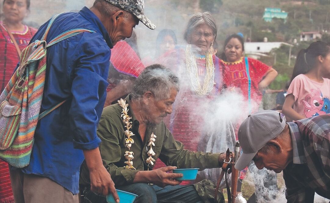 En una de las Casas de la Lluvia, el rezandero principal alza una jícara de tepache y comienza a hablar en su lengua. Foto: de Juana García