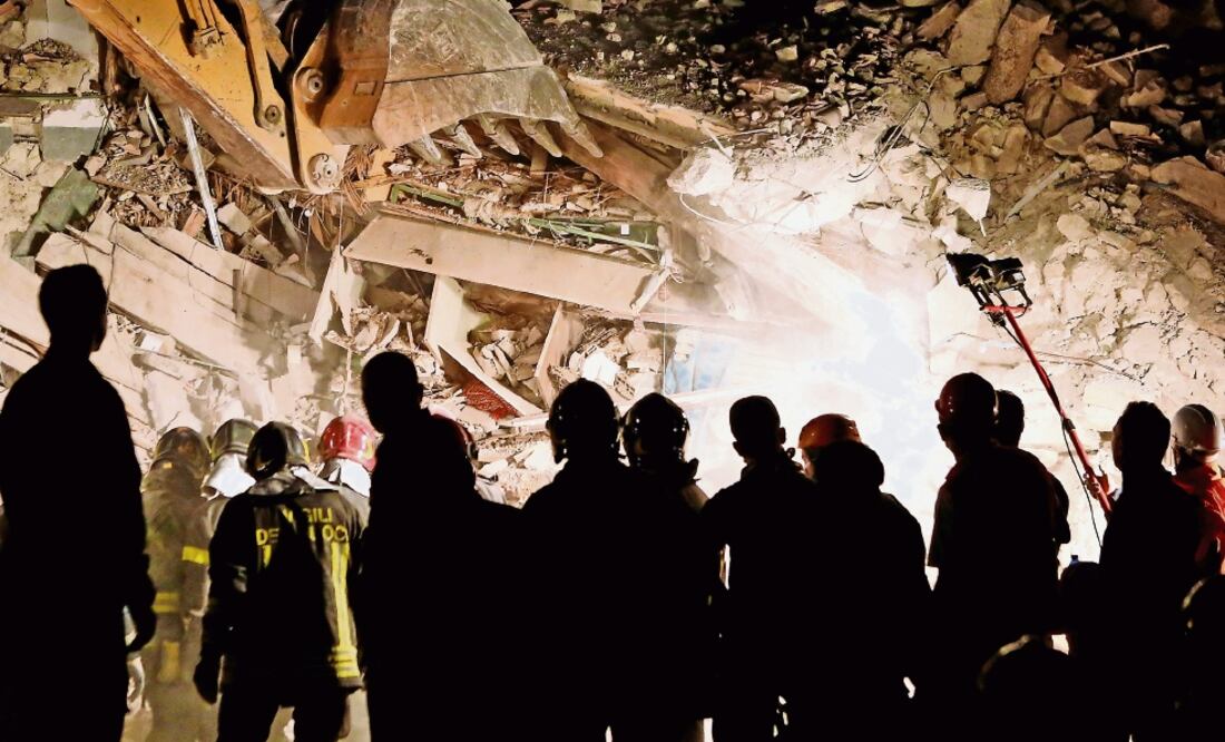 Rescatistas buscaban anoche en Pescara del Tronto sobrevivientes de una casa colapsada tras el terremoto que sacudió el centro de Italia (REMO CASILLI. REUTERS)