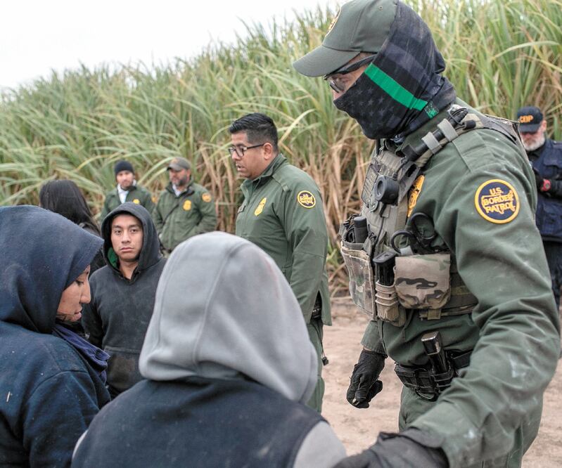 Arrestos. Agentes fronterizos al detener a indocumentados, el pasado miércoles, cerca de Mission, Texas. JOHN MOORE. AFP
