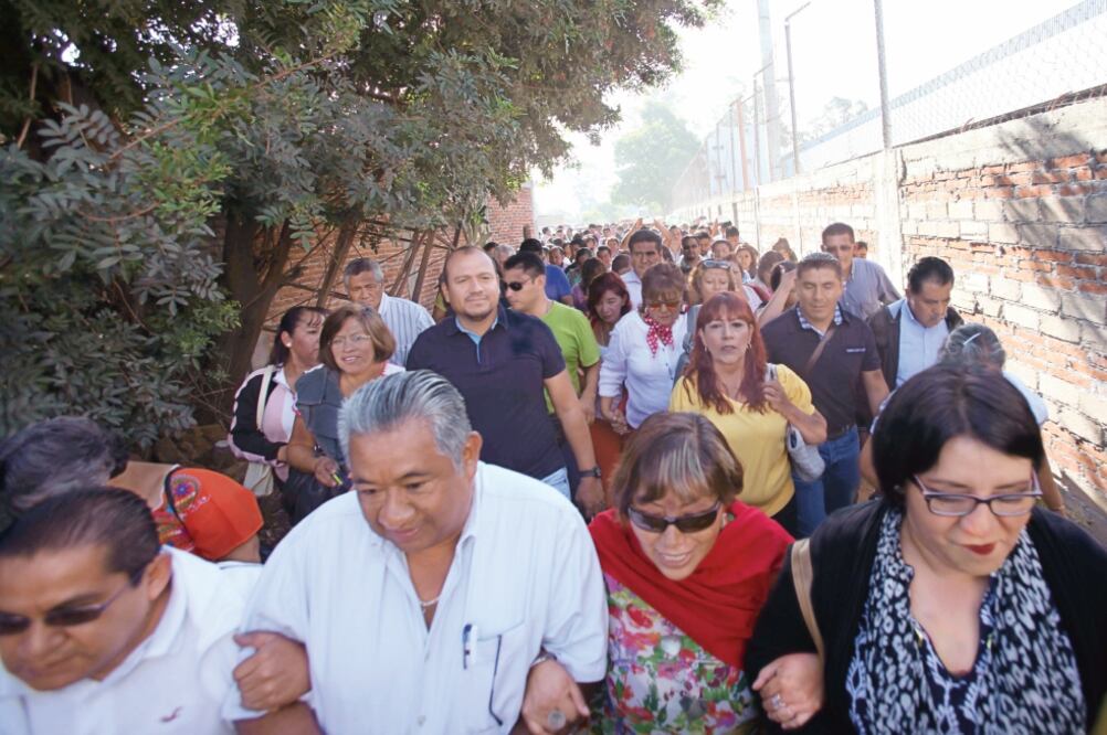Fuera de las instalaciones de la IEEPO, Francisco Villalobos (al centro con playera negra), secretario de Organización de la Sección 22, se reunió con los trabajadores a quienes convocó a rechazar las nuevas normas del instituto (VALENTE ROSAS)