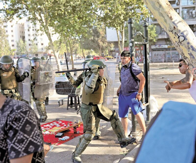 Carabineros se enfrentaron contra manifestantes durante una protesta contra el gobierno, ayer en Santiago de Chile. Foto/PABLO SANHUEZA. REUTERS