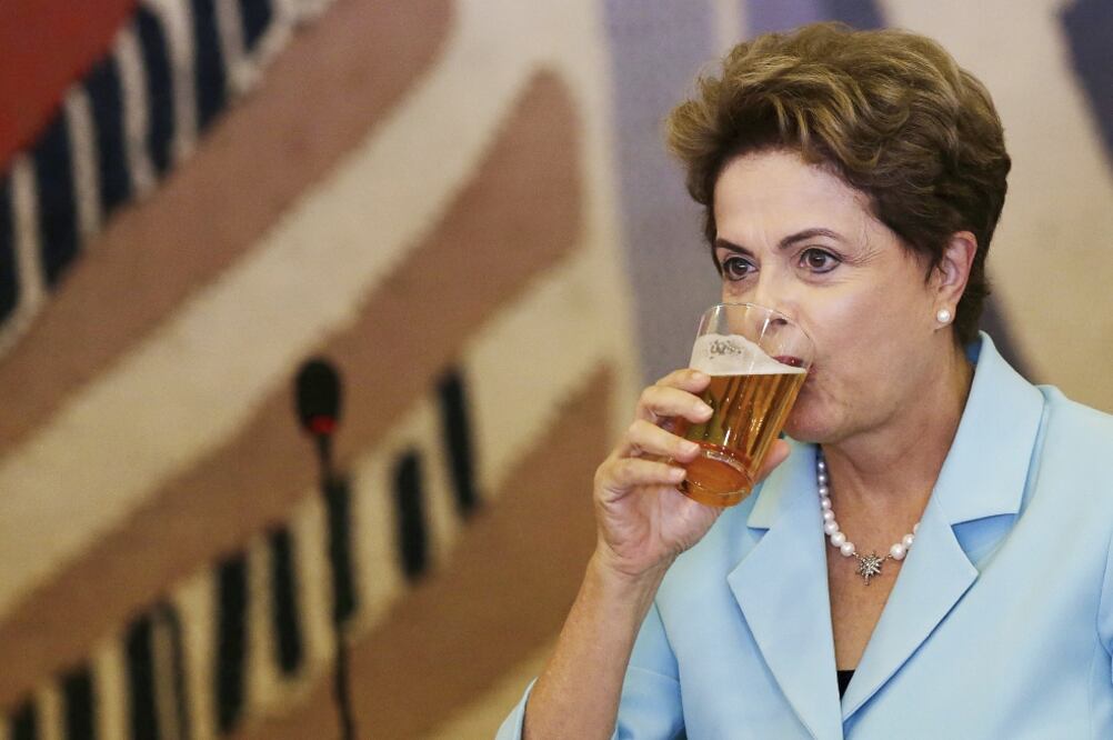 La presidenta de Brasil, Dilma Rousseff, se toma una cerveza, durante un almuerzo con la canciller alemana Angela Merkel (no aparece en la foto), el jueves, en el Palacio de Itamaraty, en Brasilia (UESLEI MARCELINO. REUTERS)