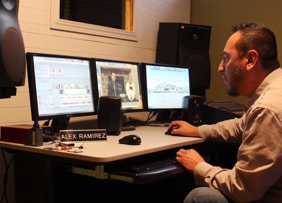 Alex Ramirez edits footage of the only community-oriented TV show in Spanish in southeast South Dakota at his studio in Sioux Falls, S.D. Ramirez, who voluntarily translates news stories and city announcements. (AP Photo/Regina Garcia Cano)