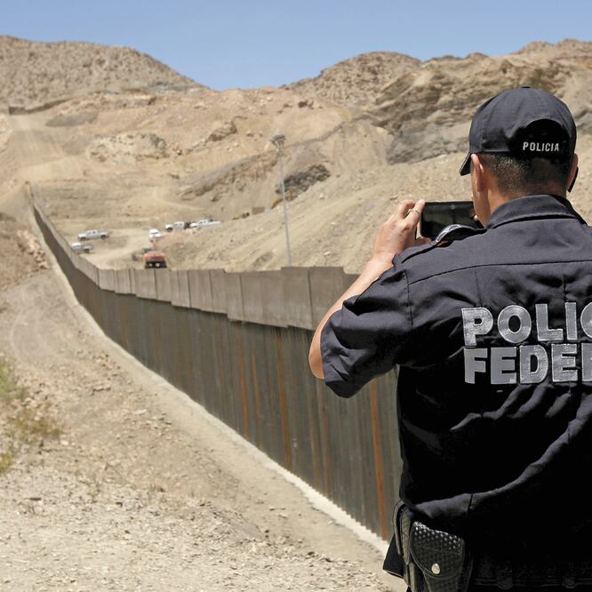 Un agente de la Policía Federal toma fotografías de la “valla privada” construida frente a Ciudad Juárez. JOSÉ LUIS GONZÁLEZ. REUTERS