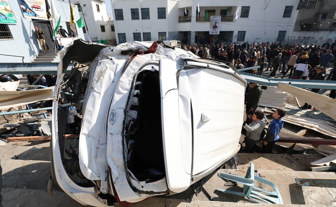 Palestinos observan un vehículo destrozado a causa de una incursión militar del Ejército israelí en el campo de refugiados de Yenín (Cisjordania). Foto: EFE