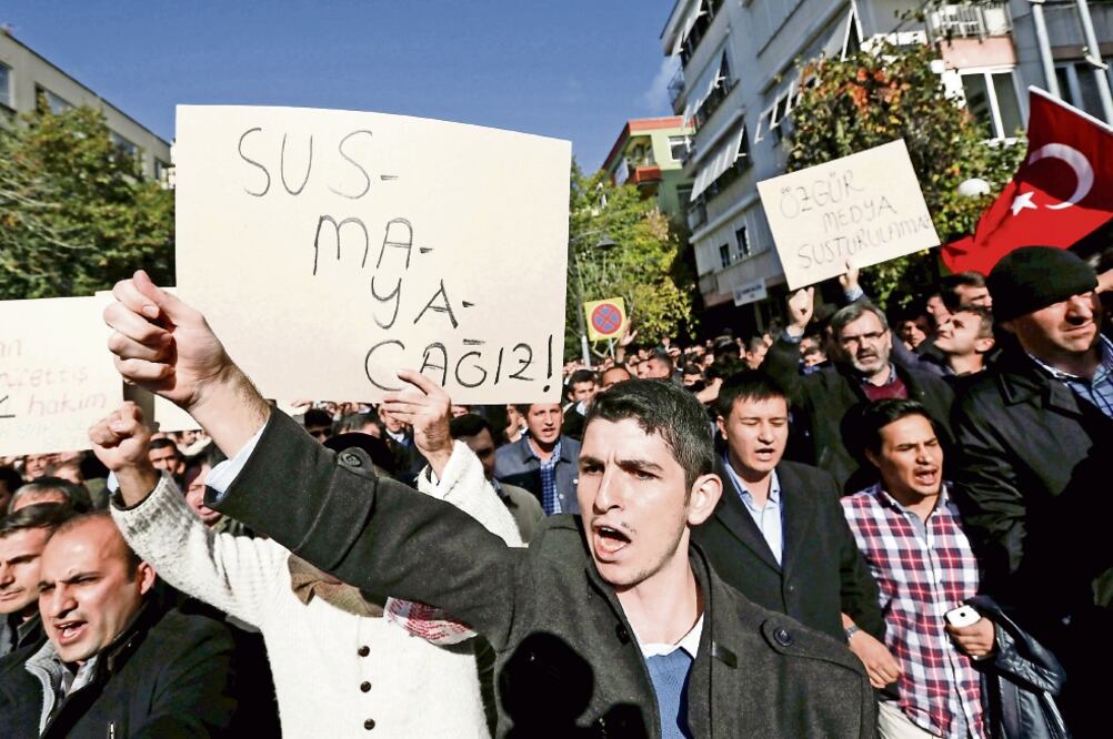 Simpatizantes de Gülen, con una pancarta en la que se lee “no nos quedaremos callados” (izq.) y otra que dice “no se puede silenciar a los medios libres”, en una protesta en Estambul (ARCHIVO. REUTERS)
