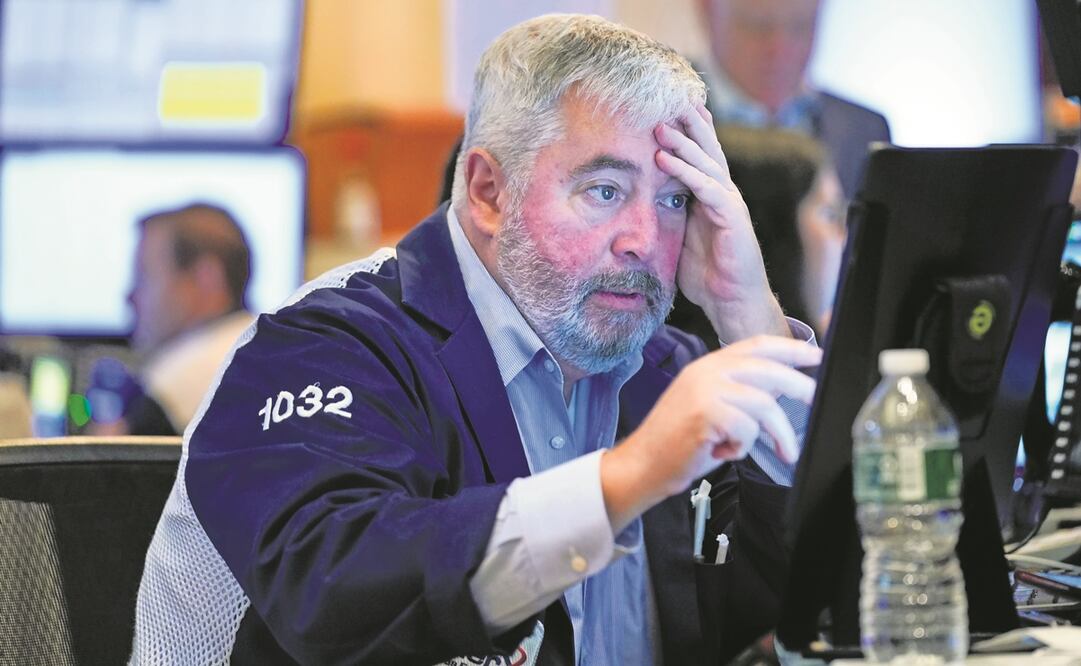 Ayer, las principales bolsas en Nueva York cerraron la jornada con caídas significativas, luego del repunte del miércoles por el alza de tasas que anunció la Fed. Foto: SETH WENIG. AP