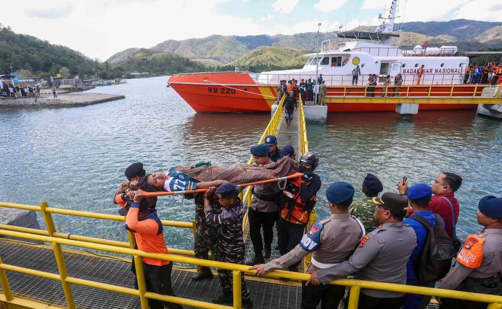 Personal de rescate, militares y policías trasladan en camilla a un pasajero evacuado desde una embarcación de búsqueda y rescate en el puerto de Lembar, en Lombok Occidental, el 12 de agosto de 2026. Un buque de la Armada y otras embarcaciones acudieron rápidamente el 12 de agosto para rescatar a más de 100 personas de un transbordador en llamas frente a la isla turística indonesia de Bali —según informaron las autoridades—, tratándose del segundo incidente de este tipo en pocos días. Foto: AFP