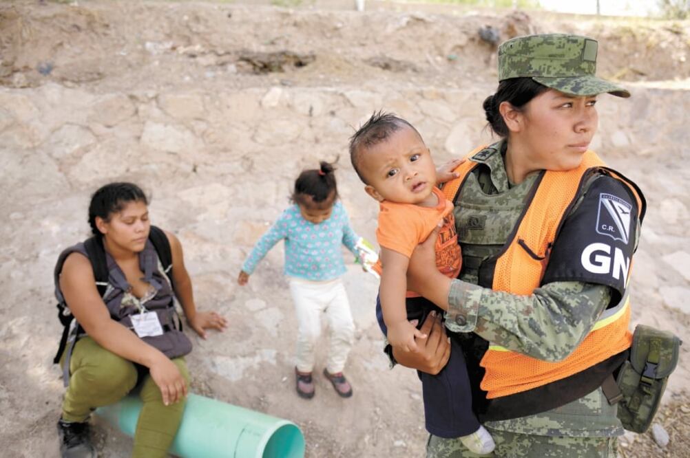 Una integrante de la Guardia Nacional carga a un bebé hondureño, en Ciudad Juárez, Chihuahua, luego de evitar que su familia cruzara hacia EU. Foto: JOSÉ LUIS GONZÁLEZ. REUTERS