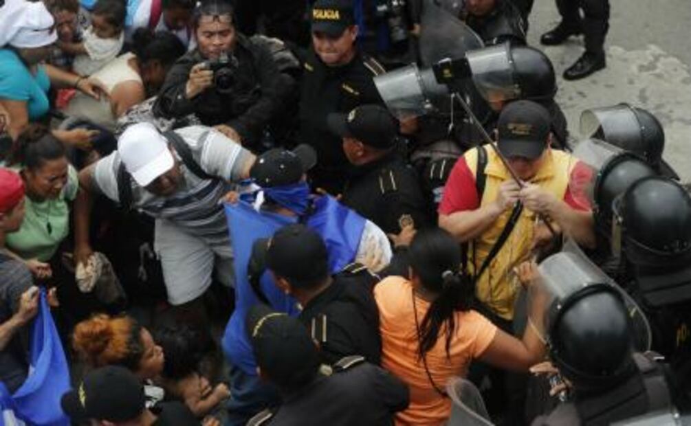 Decenas de hondureños derriban puerta en frontera guatemalteca para llegar a México