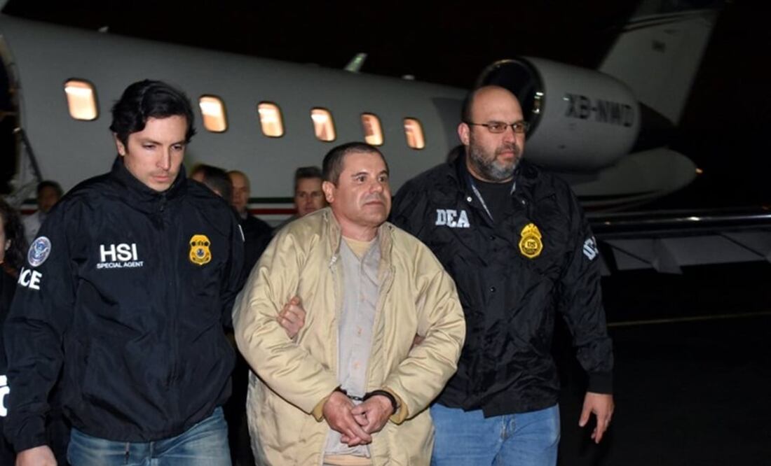 In this photo provided U.S. law enforcement, authorities escort Joaquin "El Chapo" Guzman, center, from a plane to a waiting caravan of SUVs at Long Island MacArthur Airport on Thursday, Jan. 19, 2017, in Ronkonkoma, N.Y. (U.S. law enforcement via AP)