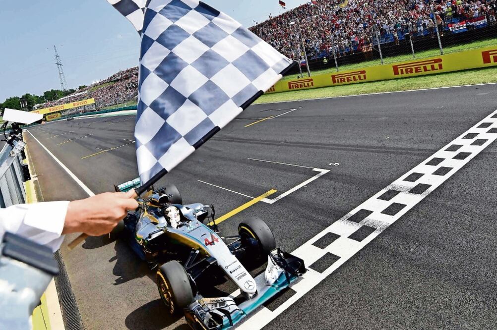 El piloto británico en el momento de recibir la bandera a cuadros (ANDREJ ISAKOVIC. REUTERS)