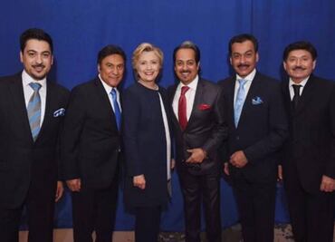 Los Tigres del Norte and Hillary Clinton pose together in a photo